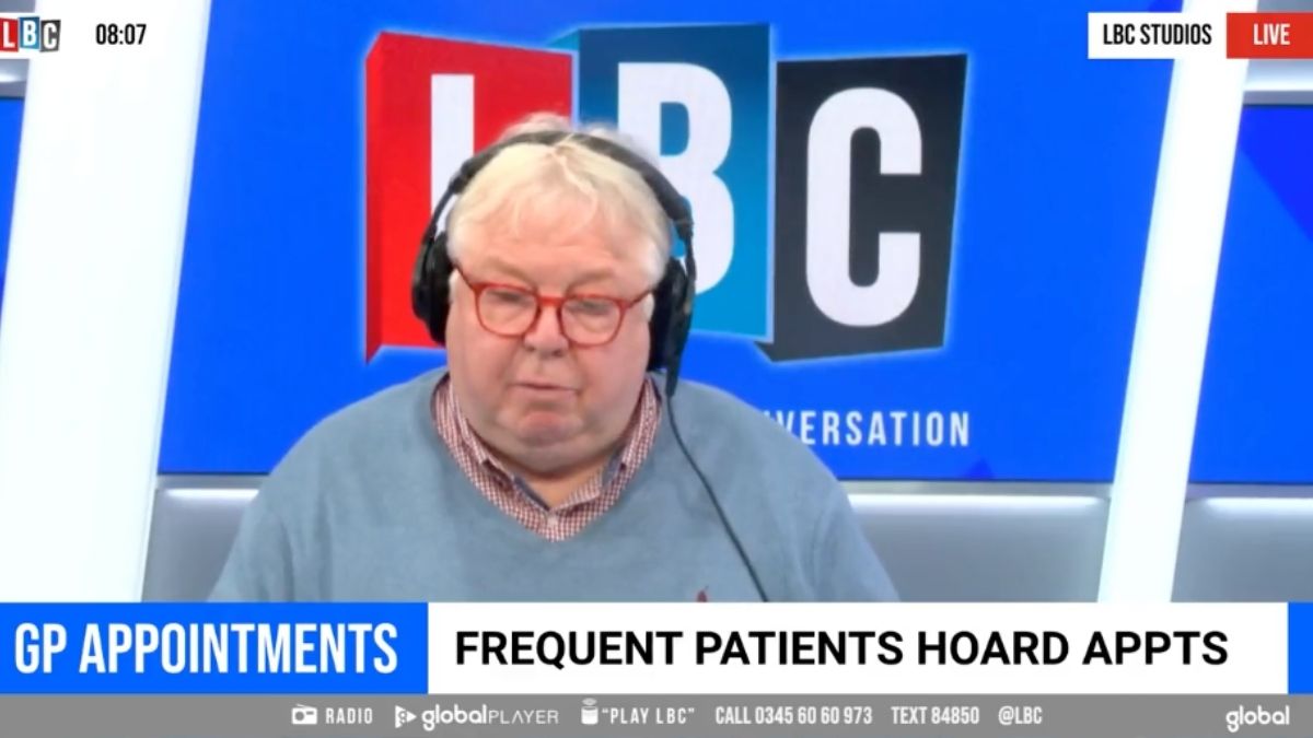 Nick Ferrari, a white man with short white hair and a blue jumper, talks in the LBC radio studio. Strapline text at the bottom reads: 'GP appointments. Frequent patients hoard appts'.